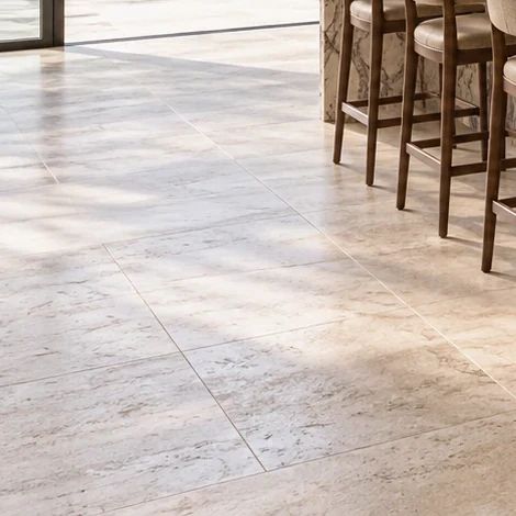 Large-format stone-look floor tiles in warm sunlight
